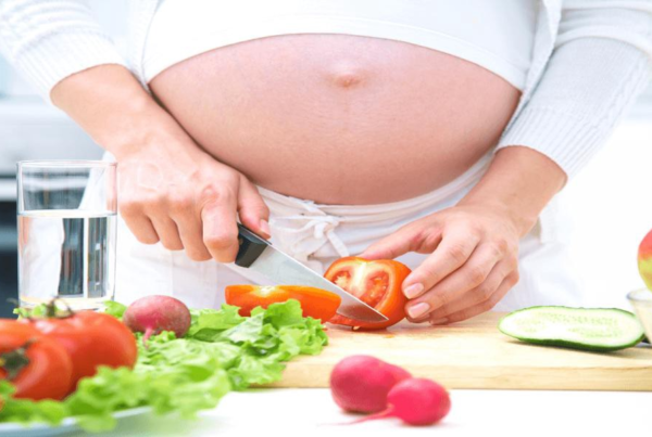 Pregnant mom preparing the salad - Joy of Life Surrogacy