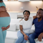 Surrogate Mother In Front Of Happy Intended Parents