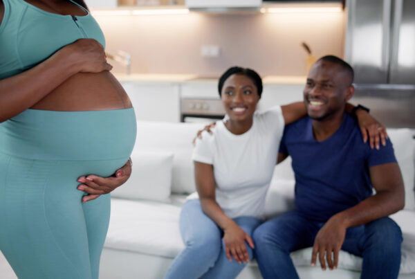 Surrogate Mother In Front Of Happy Intended Parents