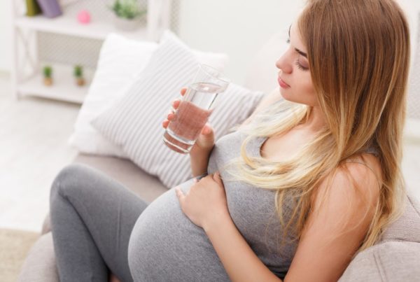 A Surrogate Mother Drinking a cup of water - Joy of Life Surrogacy