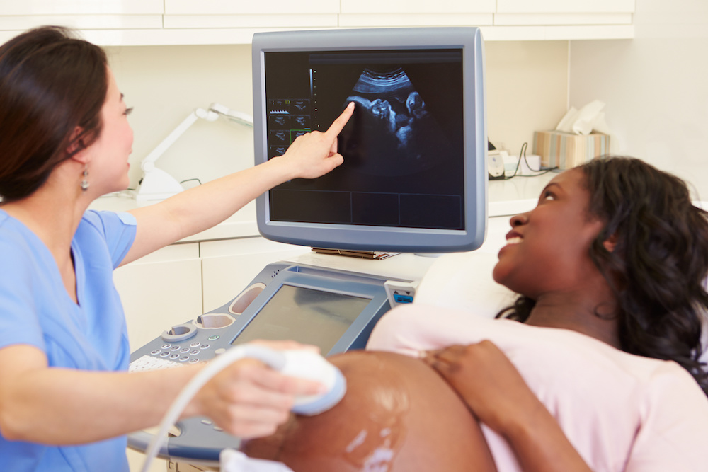 Pregnant surrogate receiving an ultrasound