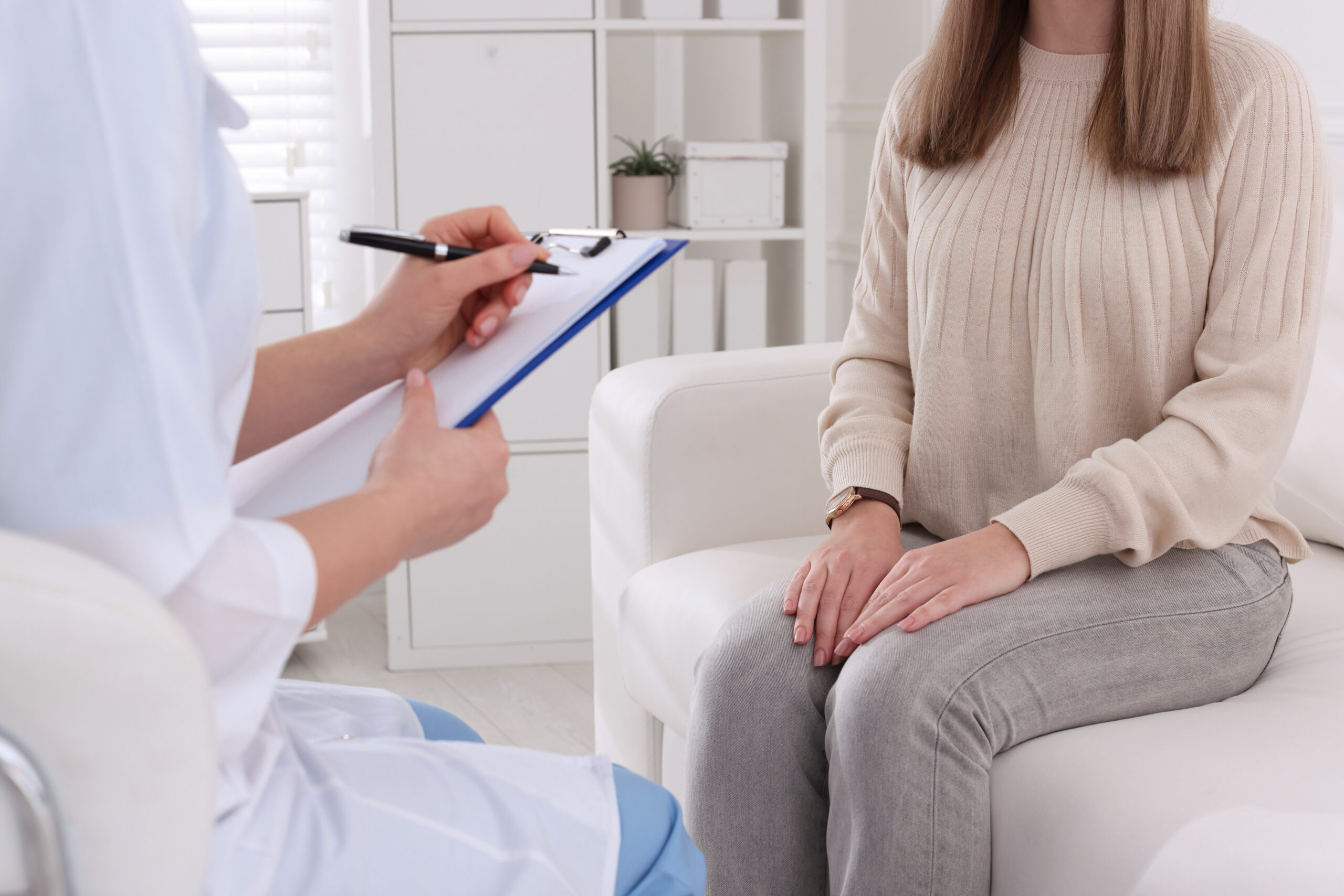 A potential surrogate sits across from a medical professional who is conducting a psychological screening.